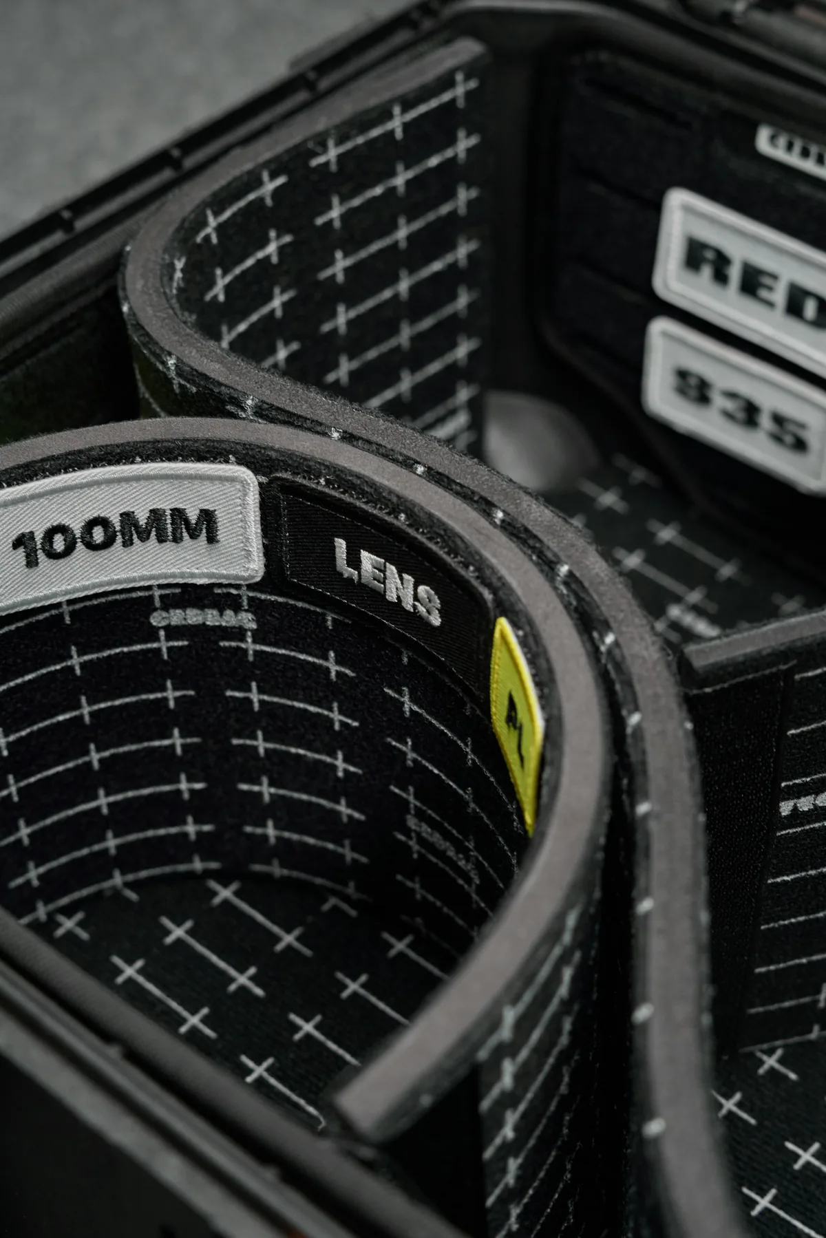 Padded compartments and labels inside a camera equipment case.