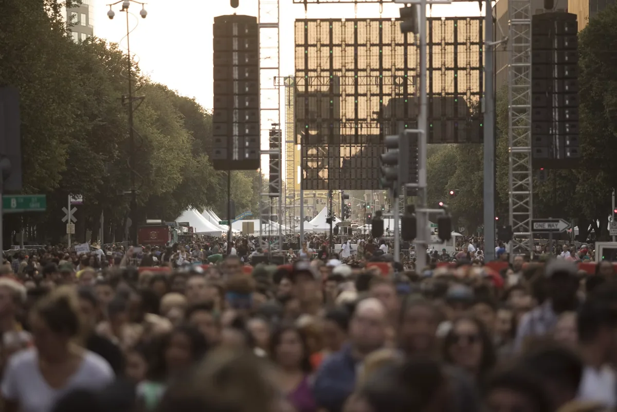 A large crowd filling a city avenue during a public gathering