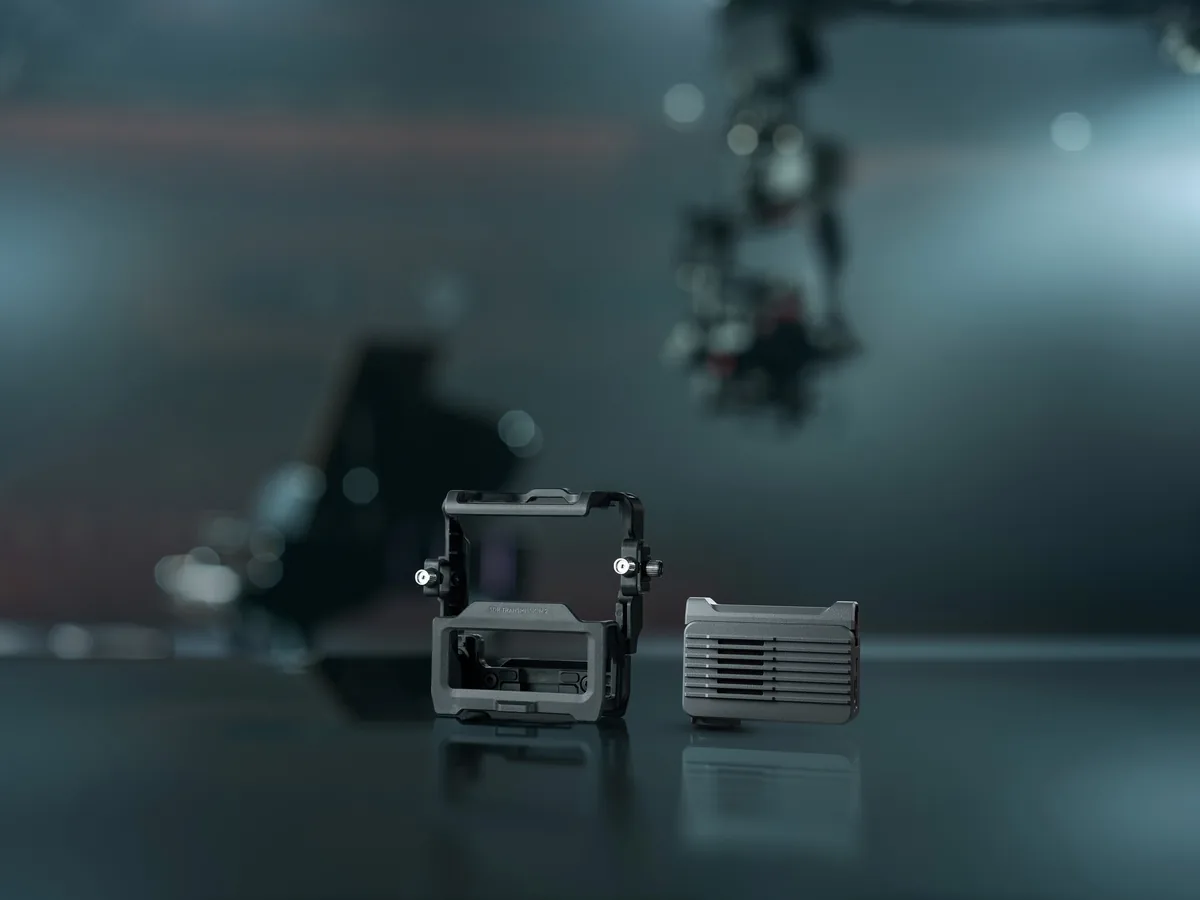 Protective cage and expansion plate for DJI SDR Transmission 2 on a dark surface.