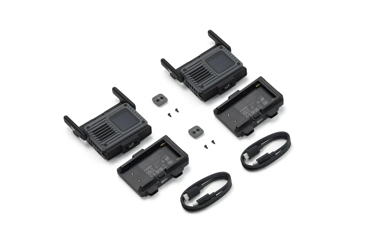 DJI SDR Transmission 2 combo components arranged on white, including two transceivers, battery adapters and cables.