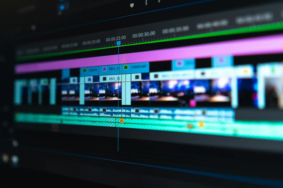 Blue, purple and green clips on a video-editing timeline.