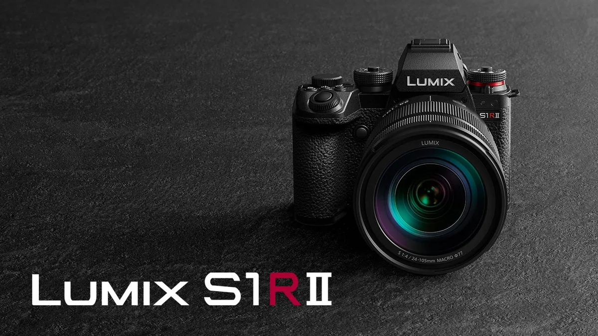 Black Panasonic LUMIX S1RII with a 24–105mm lens on a dark textured surface.