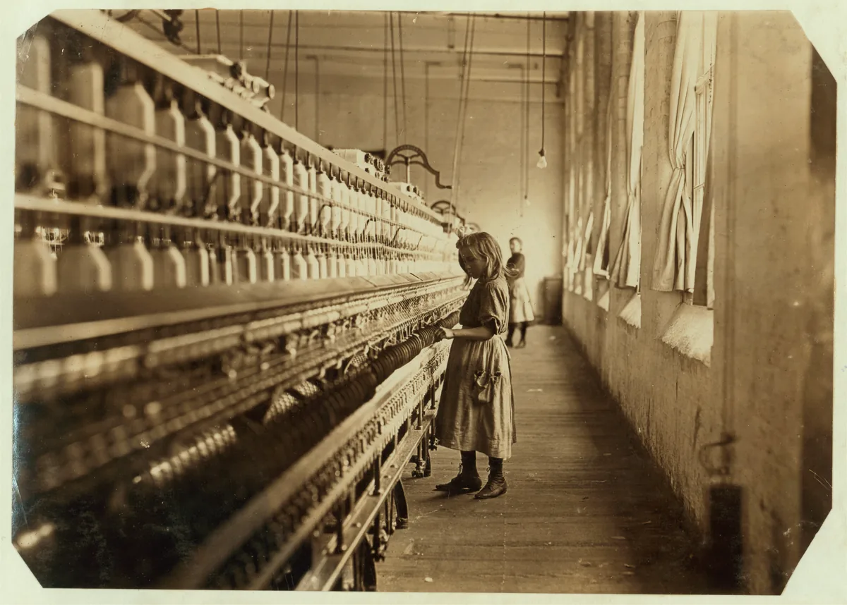 Sadie Pfeifer standing beside textile machinery at Lancaster Cotton Mills in 1908.