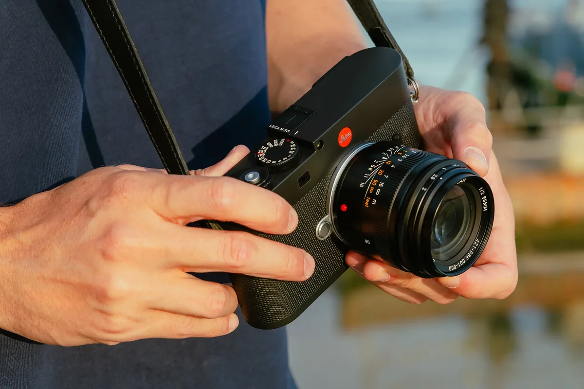 Leica M EV1 held in both hands with the Summicron-M 66 f/2 mounted