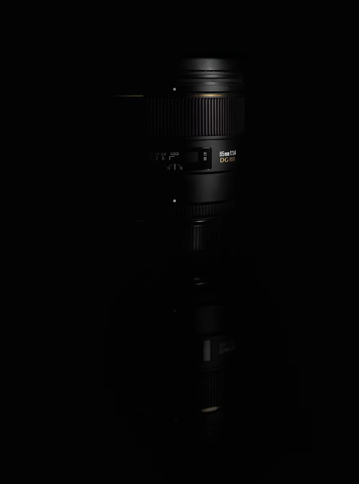 Prime camera lens resting on a dark surface