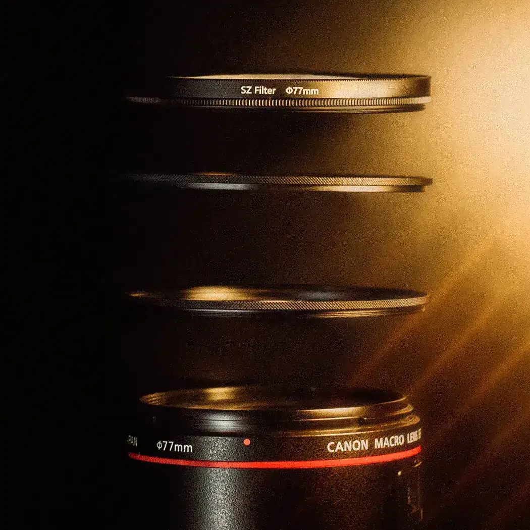 SZ Filters promotional arrangement of separated 77mm rings above a Canon macro lens.