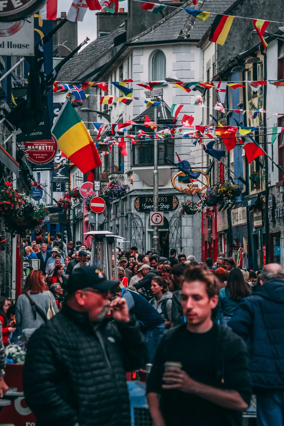 Pedestrians moving through a lively market street