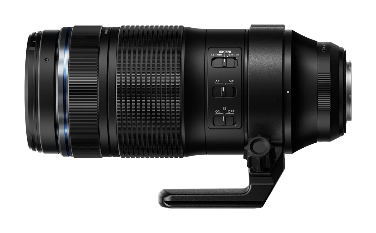 Side profile of the OM SYSTEM M.Zuiko 100–400mm IS II lens with control switches and tripod foot.