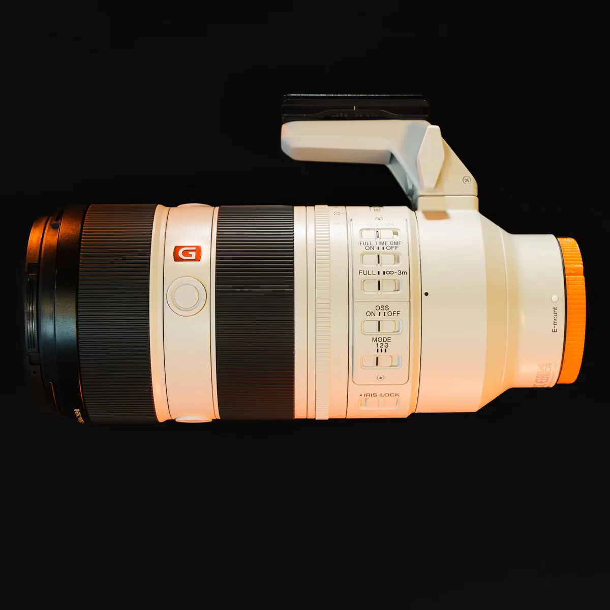 Sony G Master telephoto lens showing focus and zoom rings, aperture ring and side switches