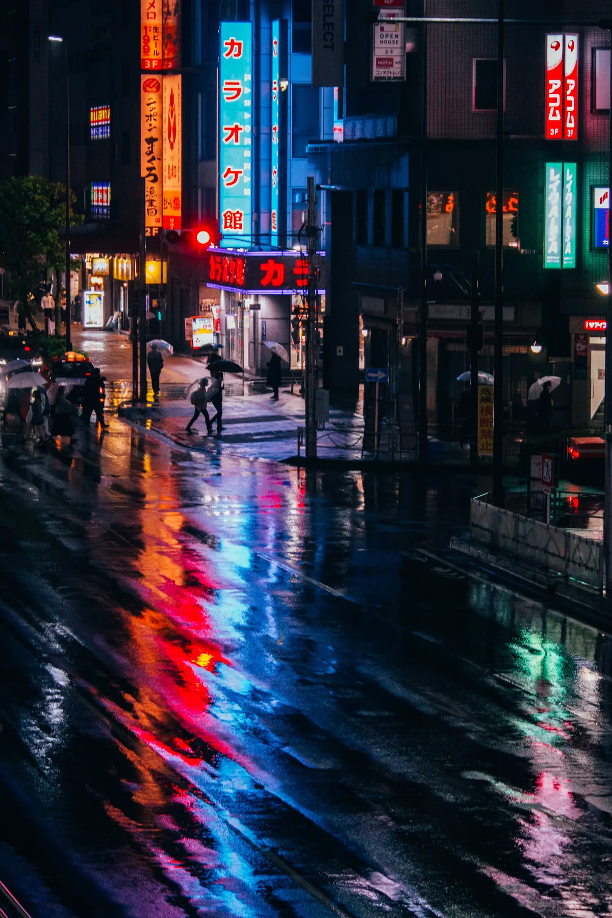 Colorful signs reflected in puddles on a rainy night