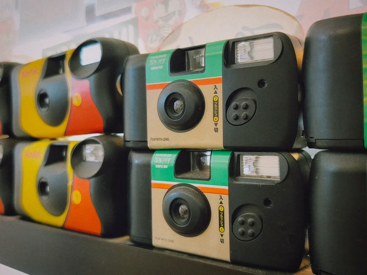 A colorful stack of single-use film cameras