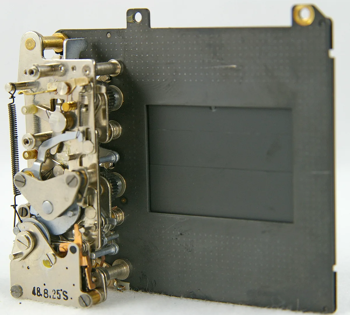 Removed Yashica TL Electro-X focal-plane shutter assembly with overlapping blades and release mechanism.
