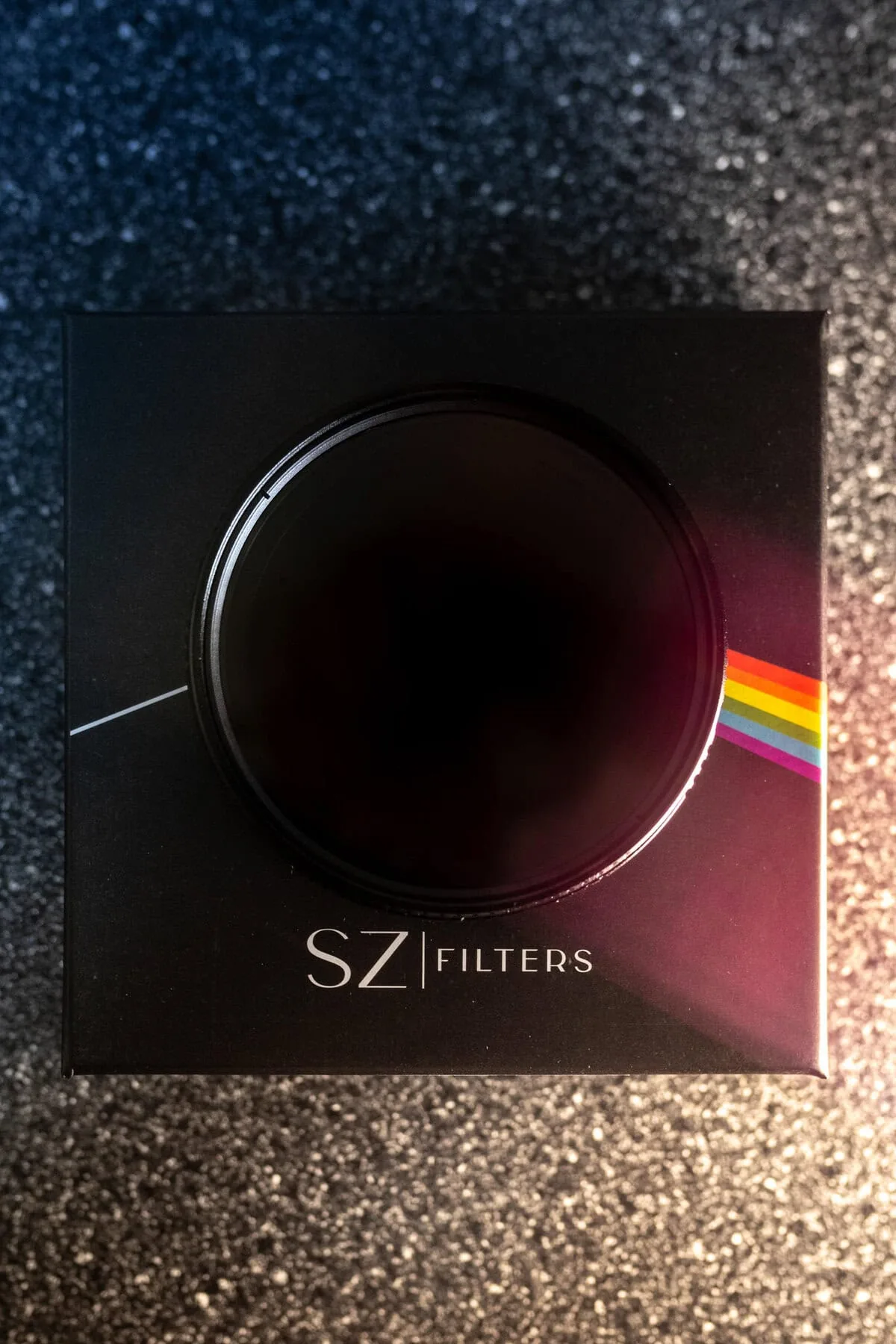 SZ Filters VND resting against branded black packaging on fabric.