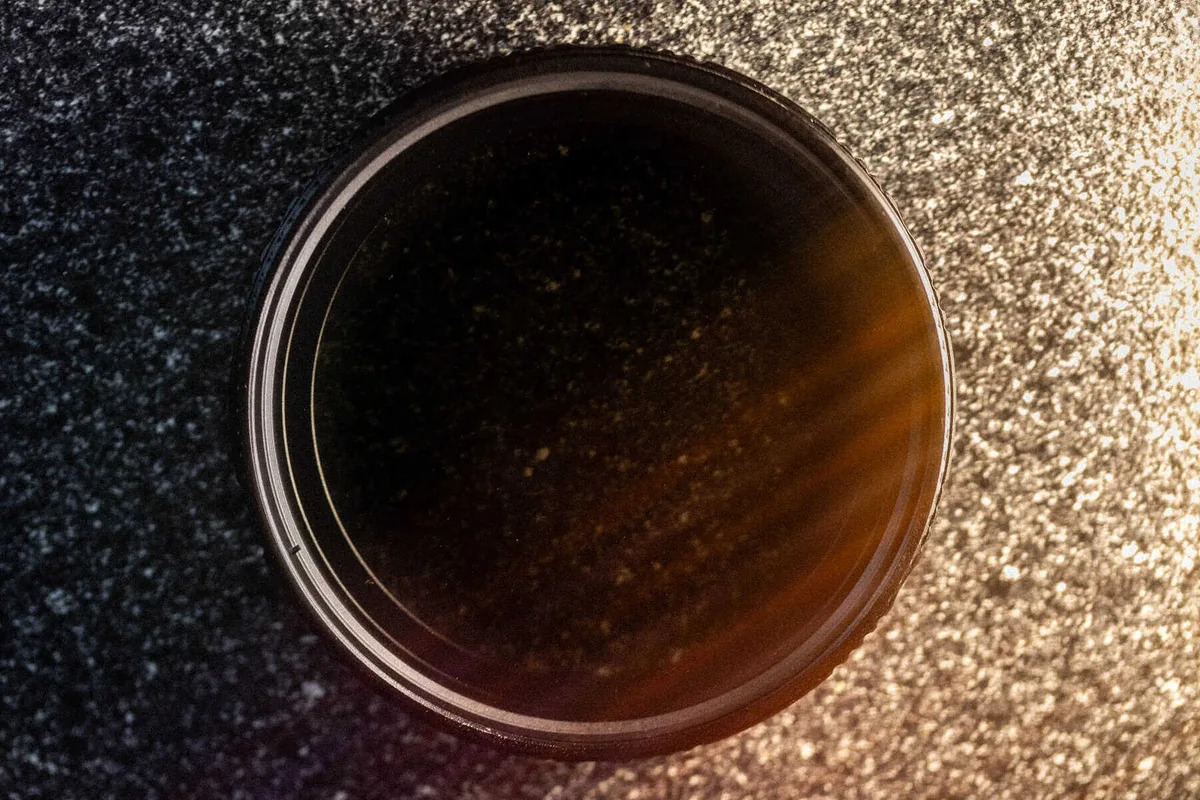 Round SZ Filters variable neutral-density filter resting on textured fabric.