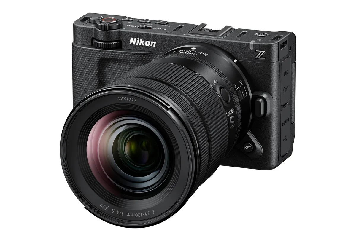 Nikon ZR cinema camera with a NIKKOR Z 24–120mm f/4 lens, viewed from the front left